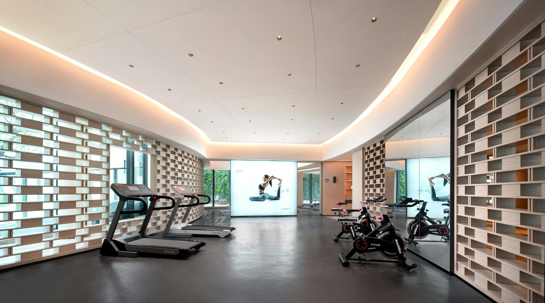 Modern gym interior with exercise equipment and open workout space for corporate wellness programs