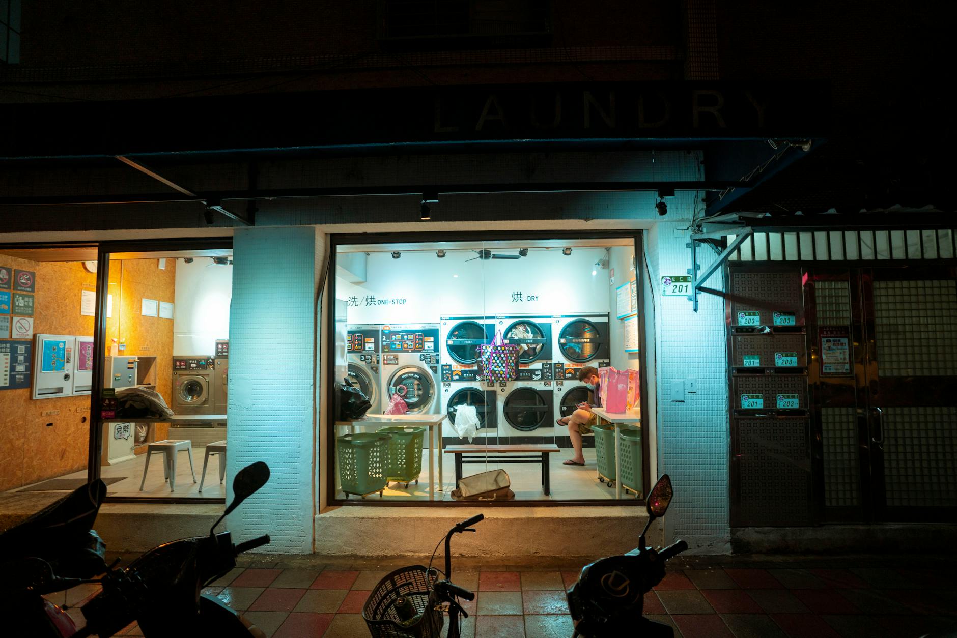 Interior view of modern laundromat with washing machines and package pickup area