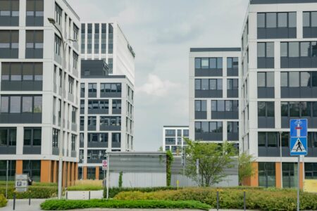 How Corporate Childcare Centers Are Becoming Employee Retention Game-Changers Modern corporate office building exterior with glass facades and landscaping