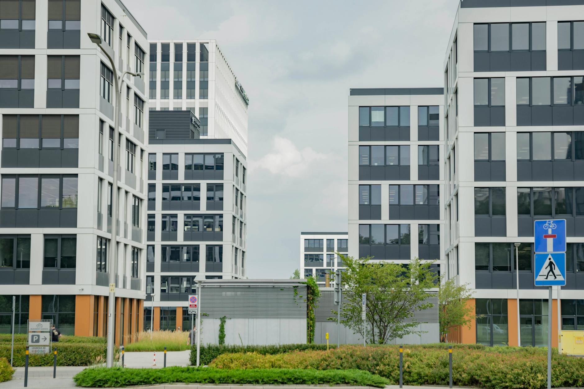 Modern corporate office building exterior with glass facades and landscaping