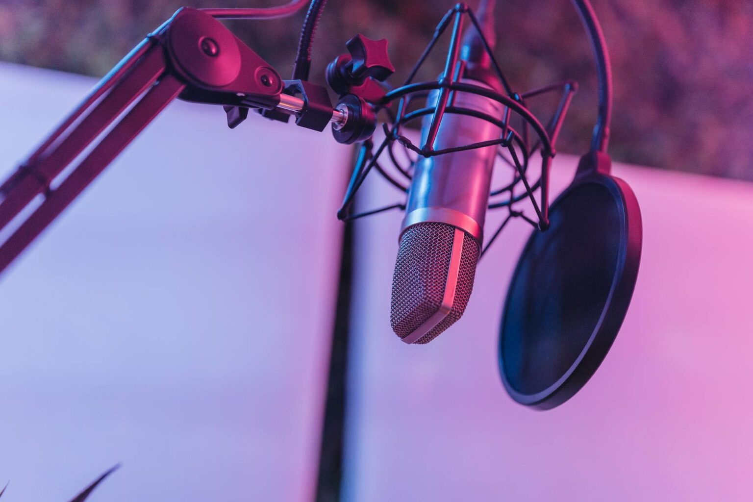Professional podcast recording setup with microphone and headphones in modern studio