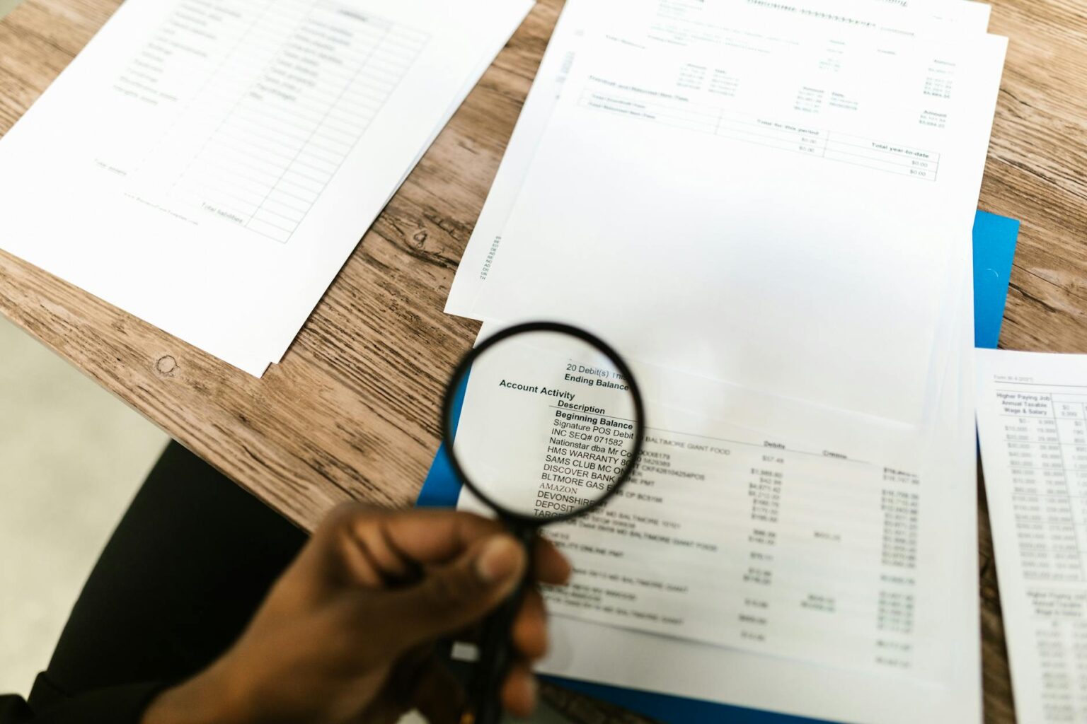 Investment documents and financial papers spread on desk showing bond certificates and financial planning materials