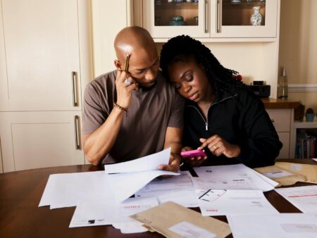 Family reviewing financial documents and planning charitable giving strategy at home