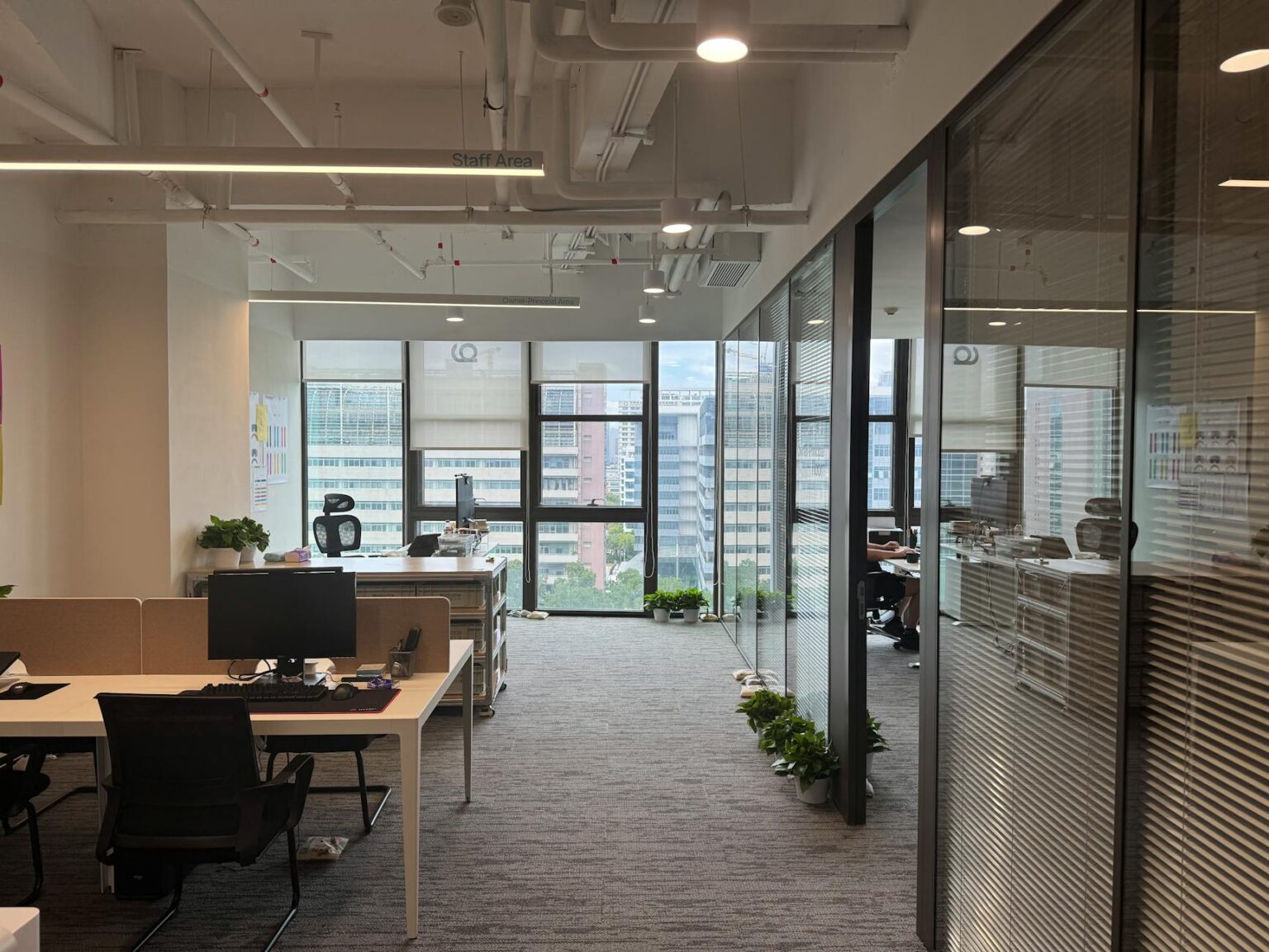 Modern corporate office space with empty desks and large windows