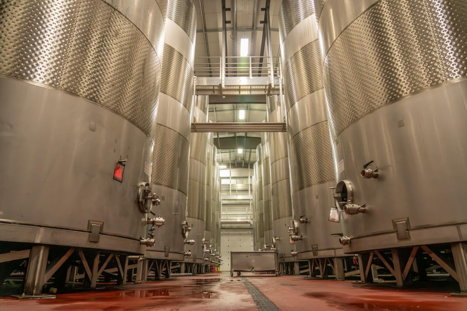 Modern brewery interior with stainless steel tanks and tasting area