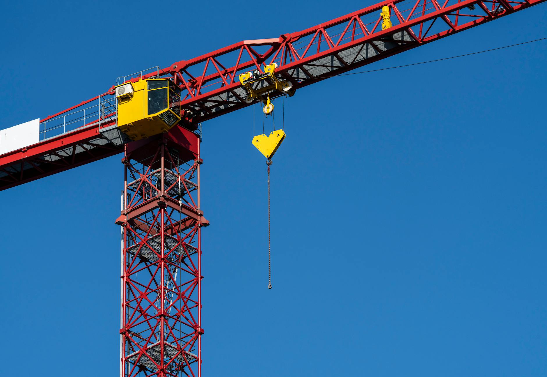 Construction crane and building site representing infrastructure development and investment opportunities