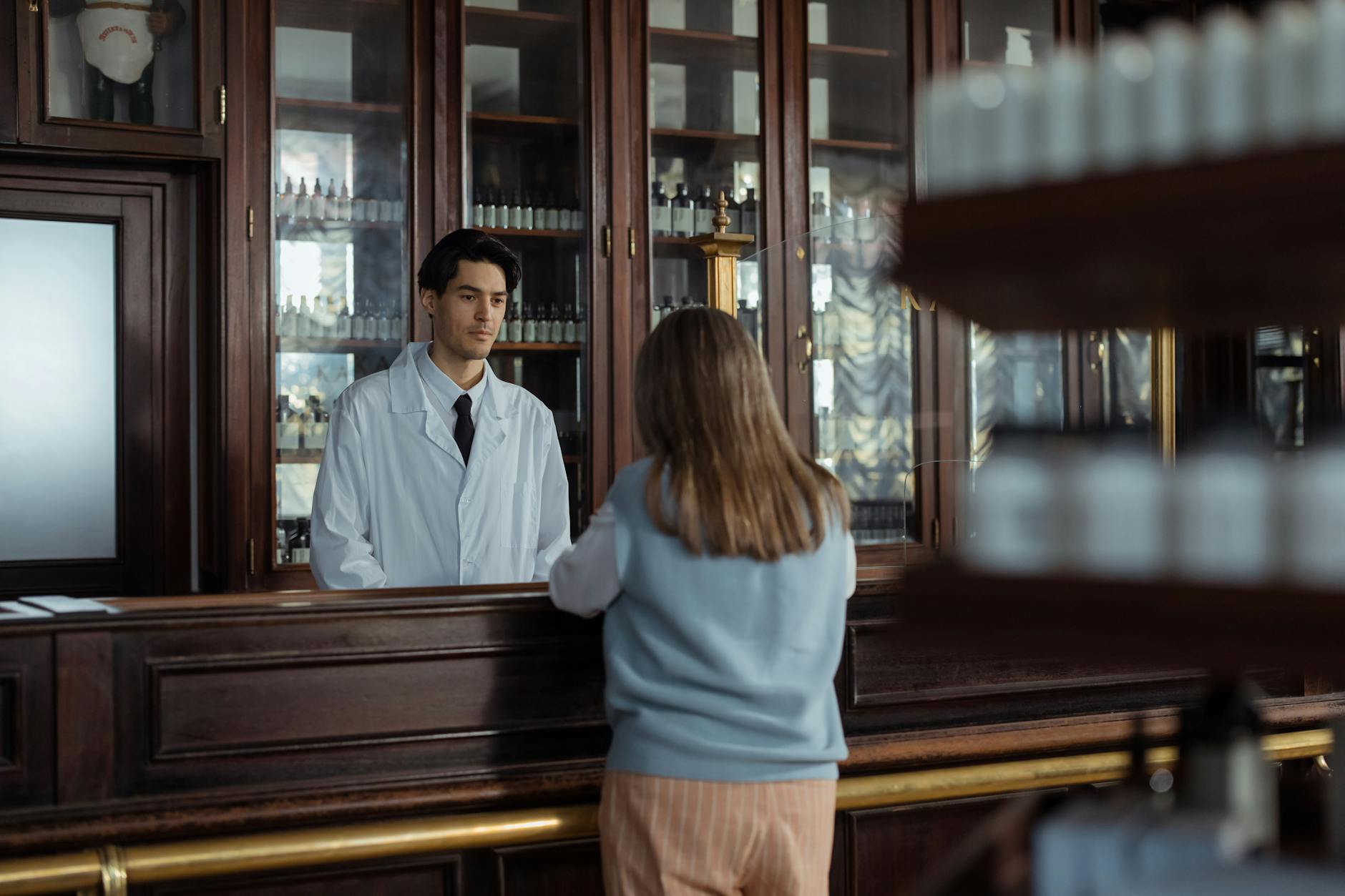 Modern pharmacy interior with consultation area and computer workstation for telehealth services