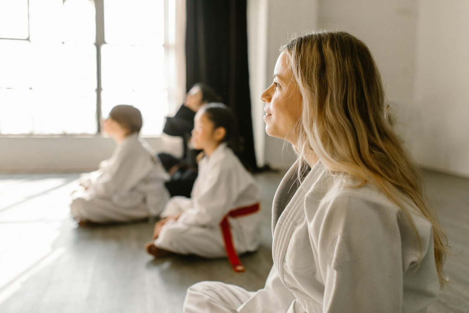 Interior view of a martial arts training studio with mats and equipment