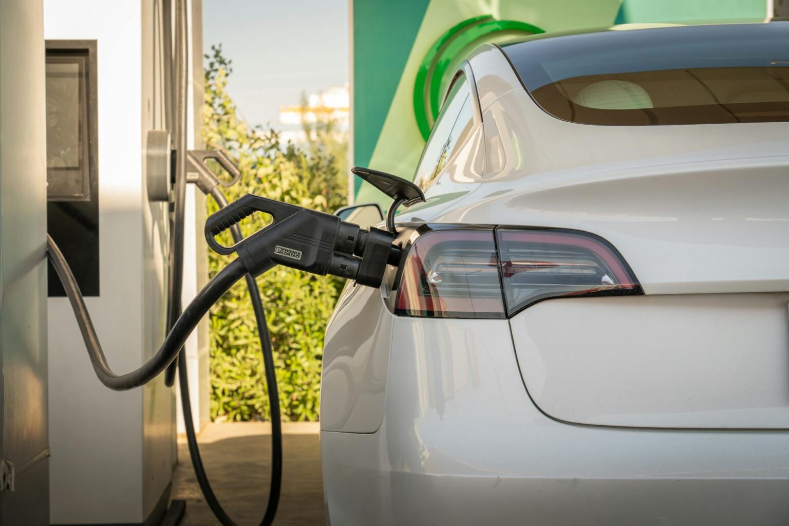 Electric Vehicle Charging Station REITs Attract Infrastructure Investors Electric vehicle connected to charging station in urban setting