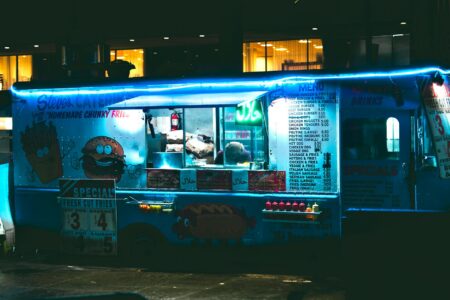 Colorful food truck parked on city street serving customers during lunch hour