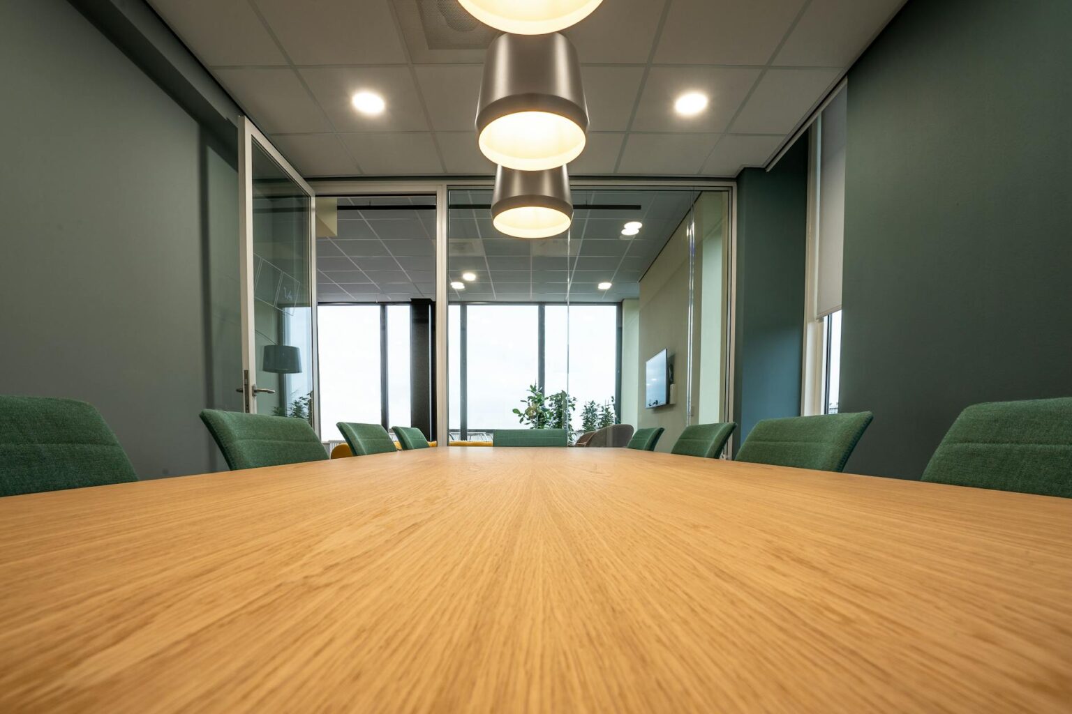 Modern office meeting room with people collaborating around a conference table