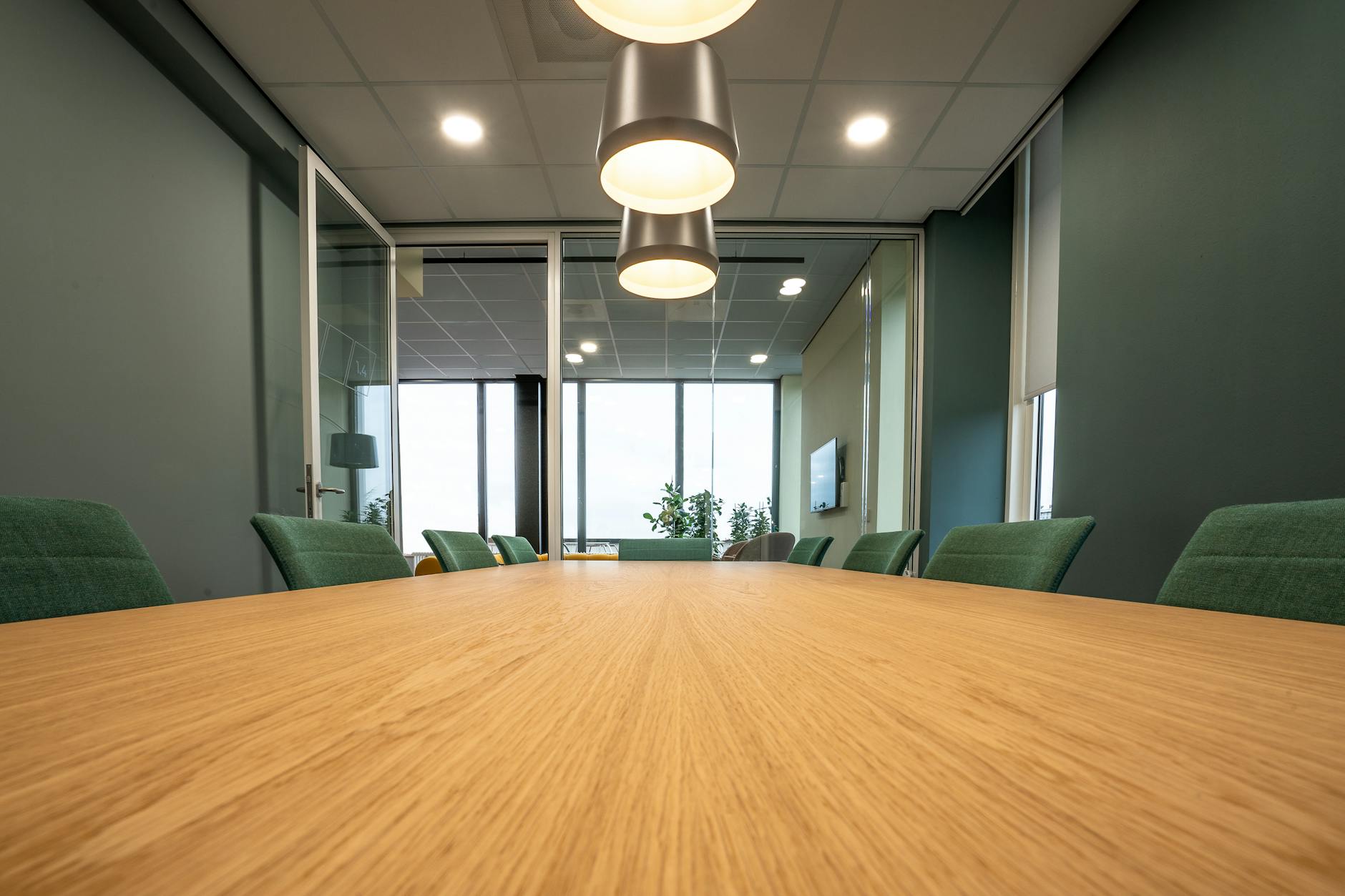 Modern office meeting room with people collaborating around a conference table