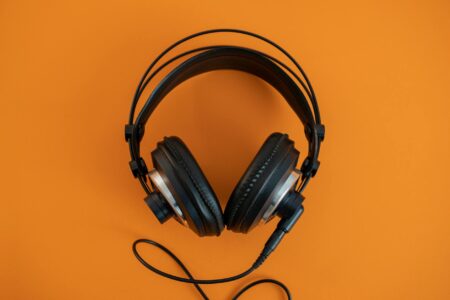 Person wearing headphones while listening to music on streaming platform