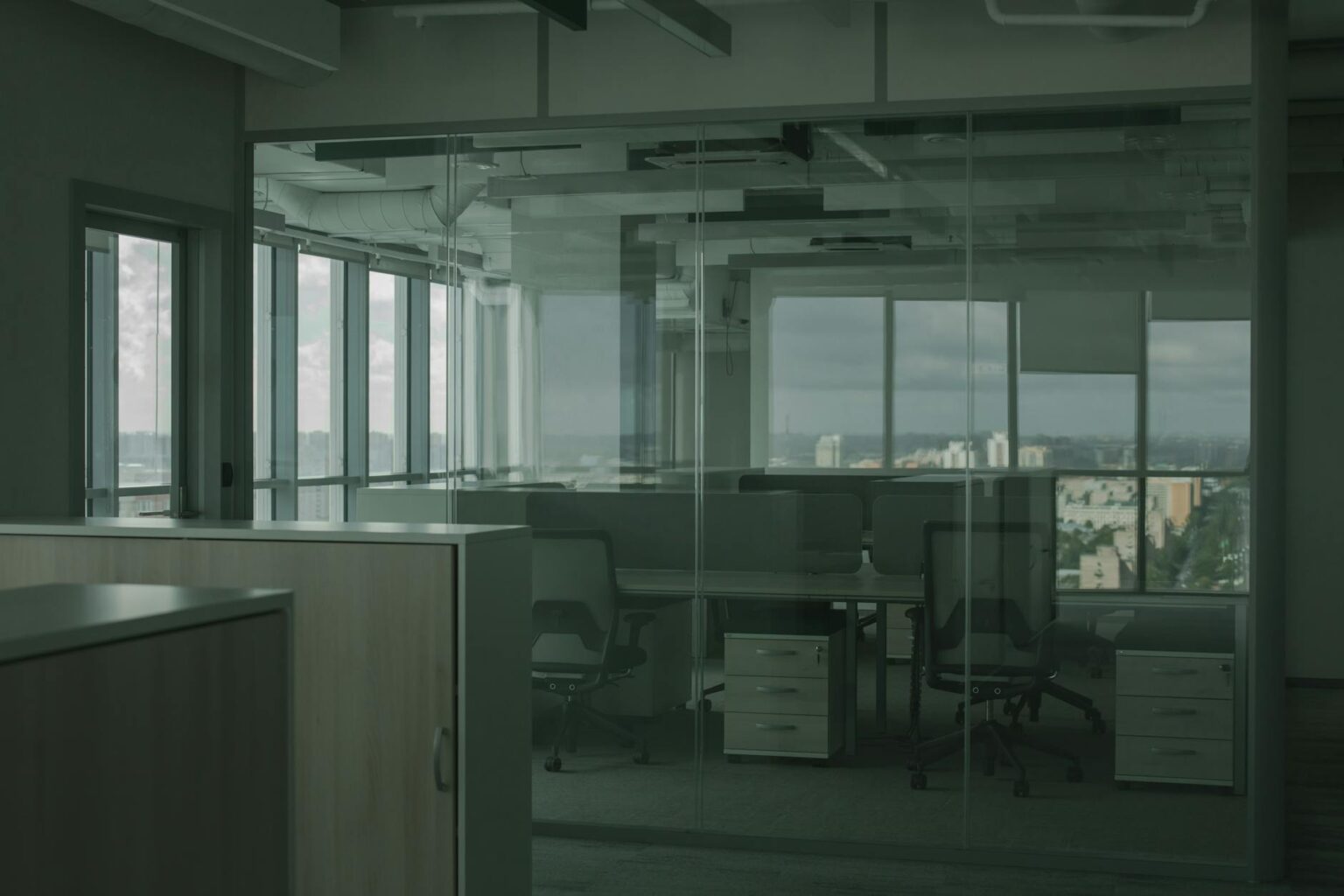 Modern empty office space with desks and chairs showing reduced occupancy from four-day work week policies