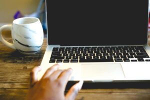 Person working on laptop in modern workspace setting