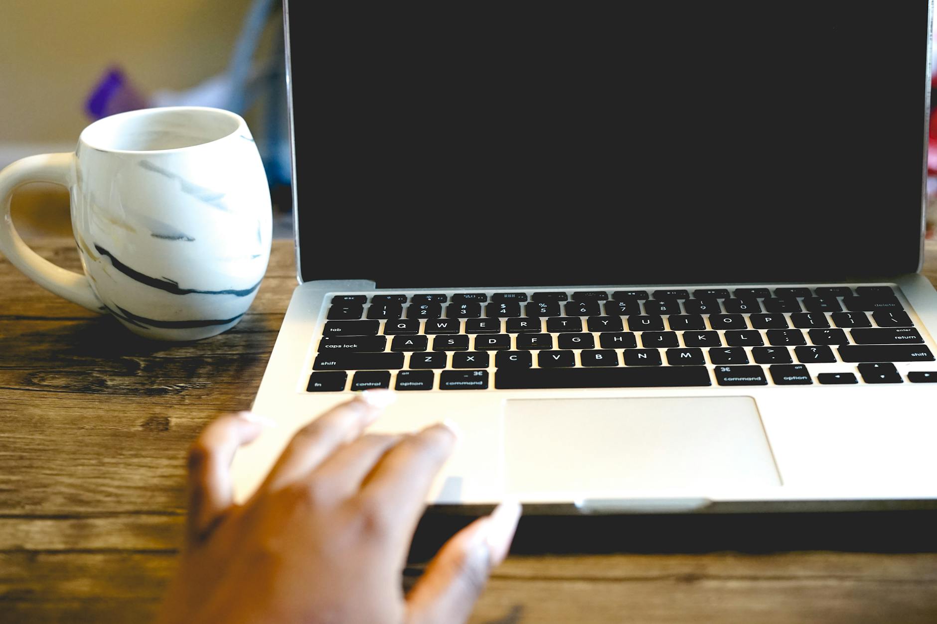 Person working on laptop in modern workspace setting