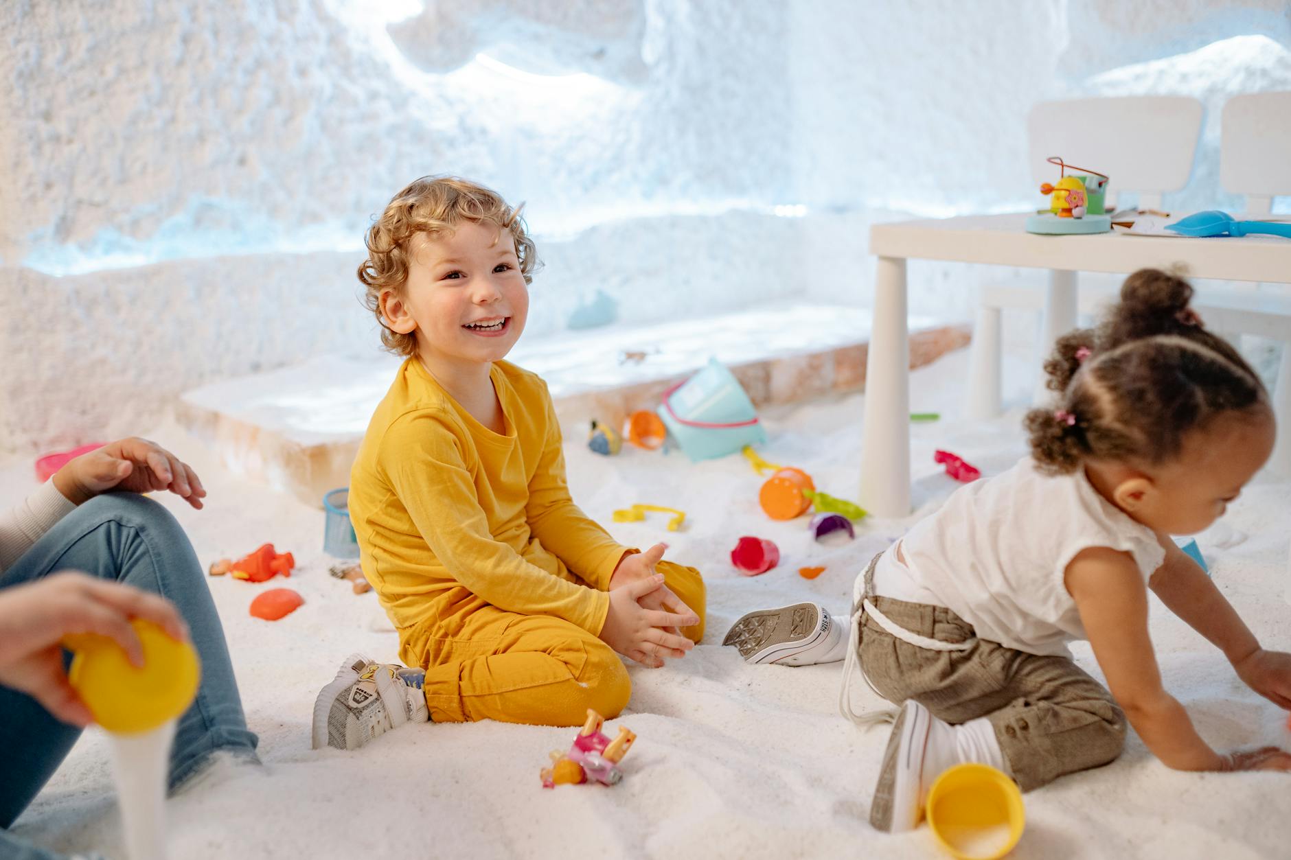 Children engaged in educational play activities in a bright indoor childcare facility