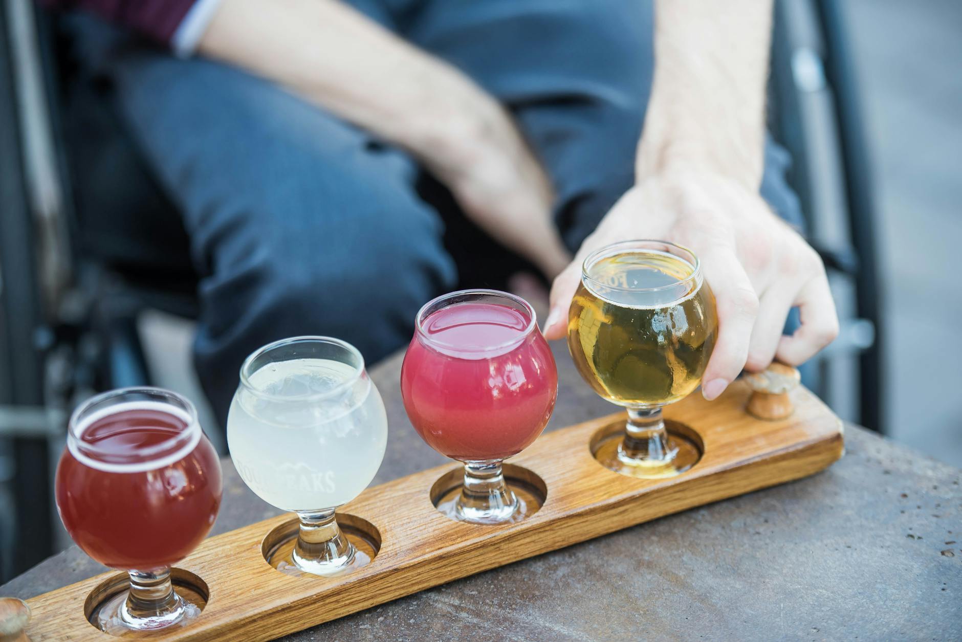 Beer tasting flight with multiple glass samples on wooden table
