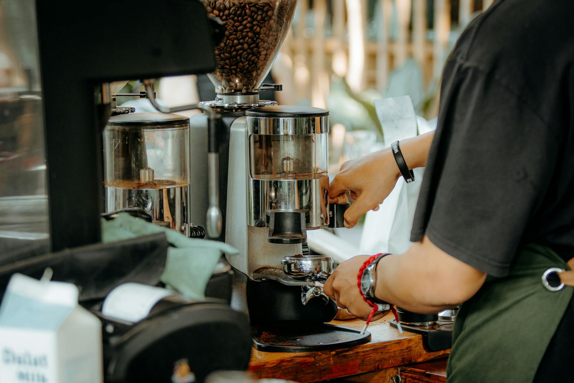 Professional barista preparing specialty coffee drinks behind espresso machine