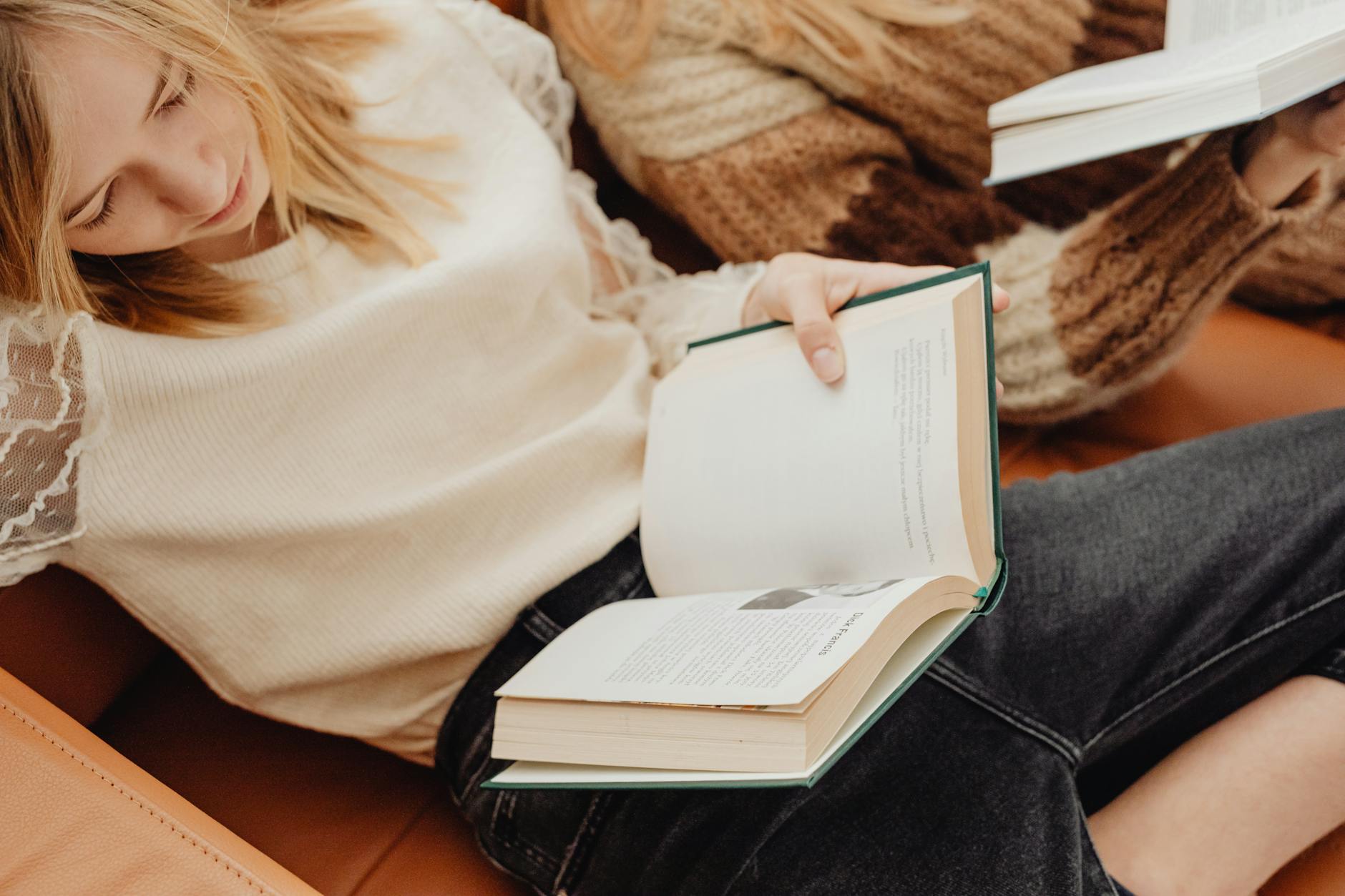 Group of people sitting in circle discussing books at community event