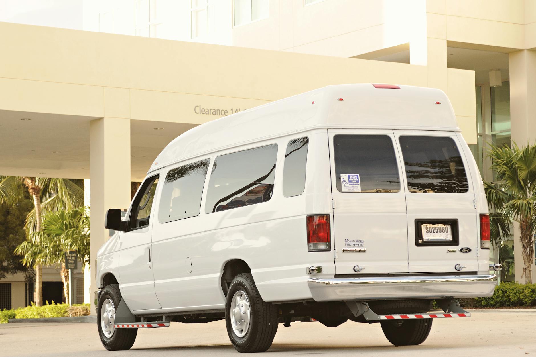 White mobile service van parked in residential neighborhood driveway
