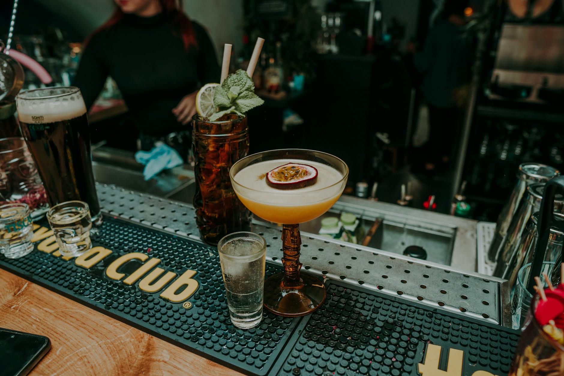 Bartender preparing premium cocktails with craft spirits in upscale bar setting