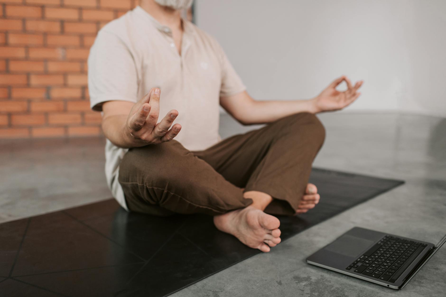 Professional woman practicing meditation in workplace wellness space during mental health break