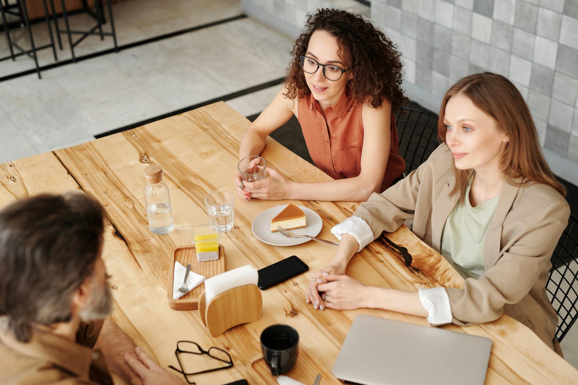 Small group of people having business meeting at coffee shop table