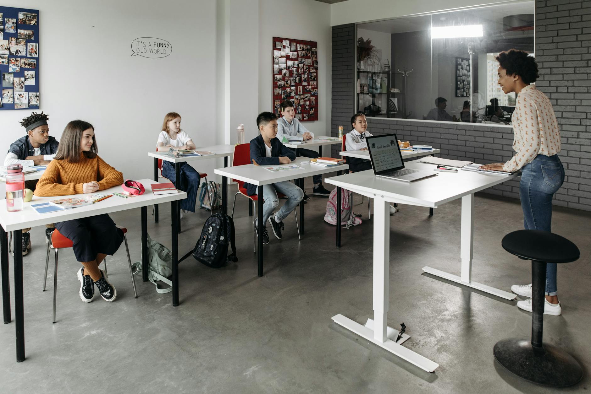Adult education classroom with students seated at tables listening to instructor