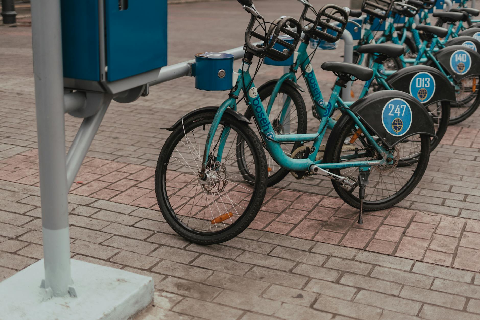Modern bike rental station with multiple electric bicycles available for rent