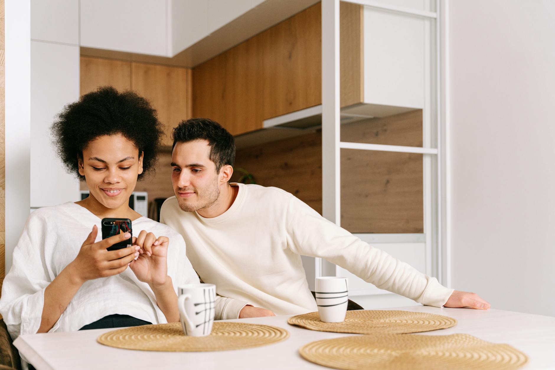 Young couple standing in front of their new home