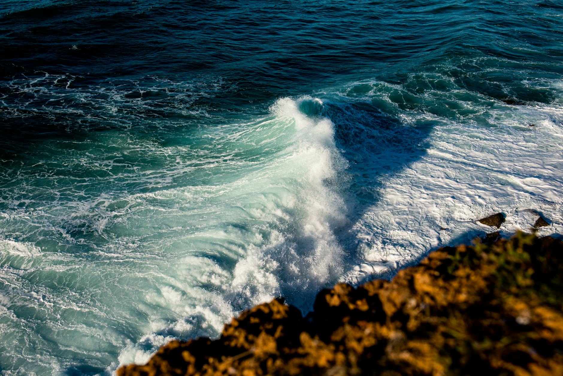 Coastal ocean waves meeting shoreline representing seawater source for desalination