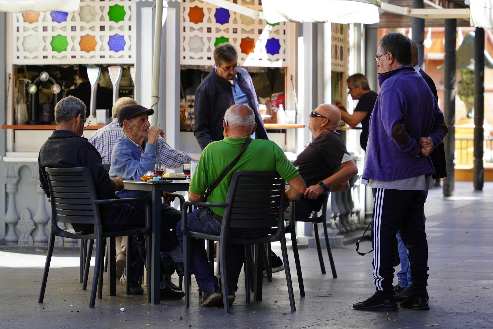 Group of people having business meeting in local coffee shop setting