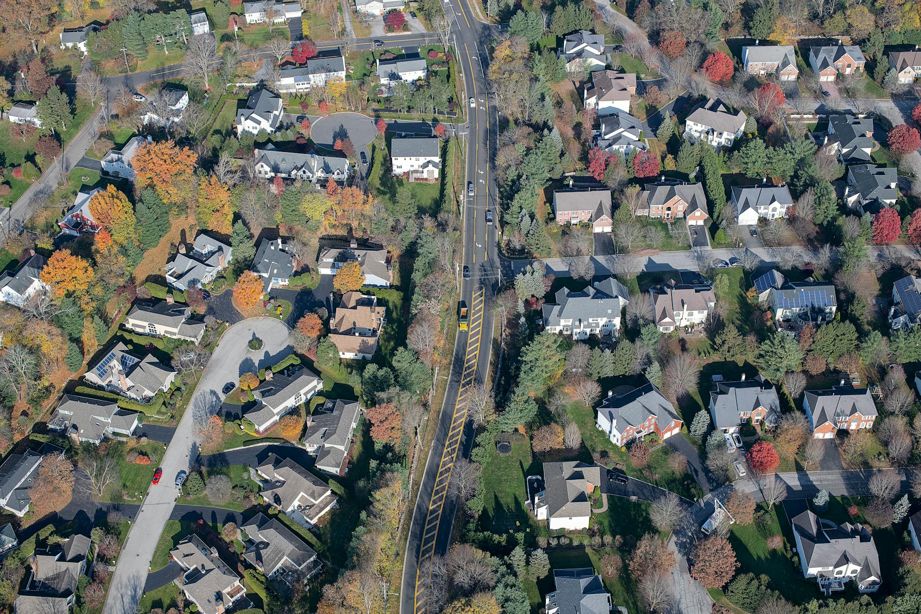 Aerial view of suburban residential neighborhood with curved streets and houses