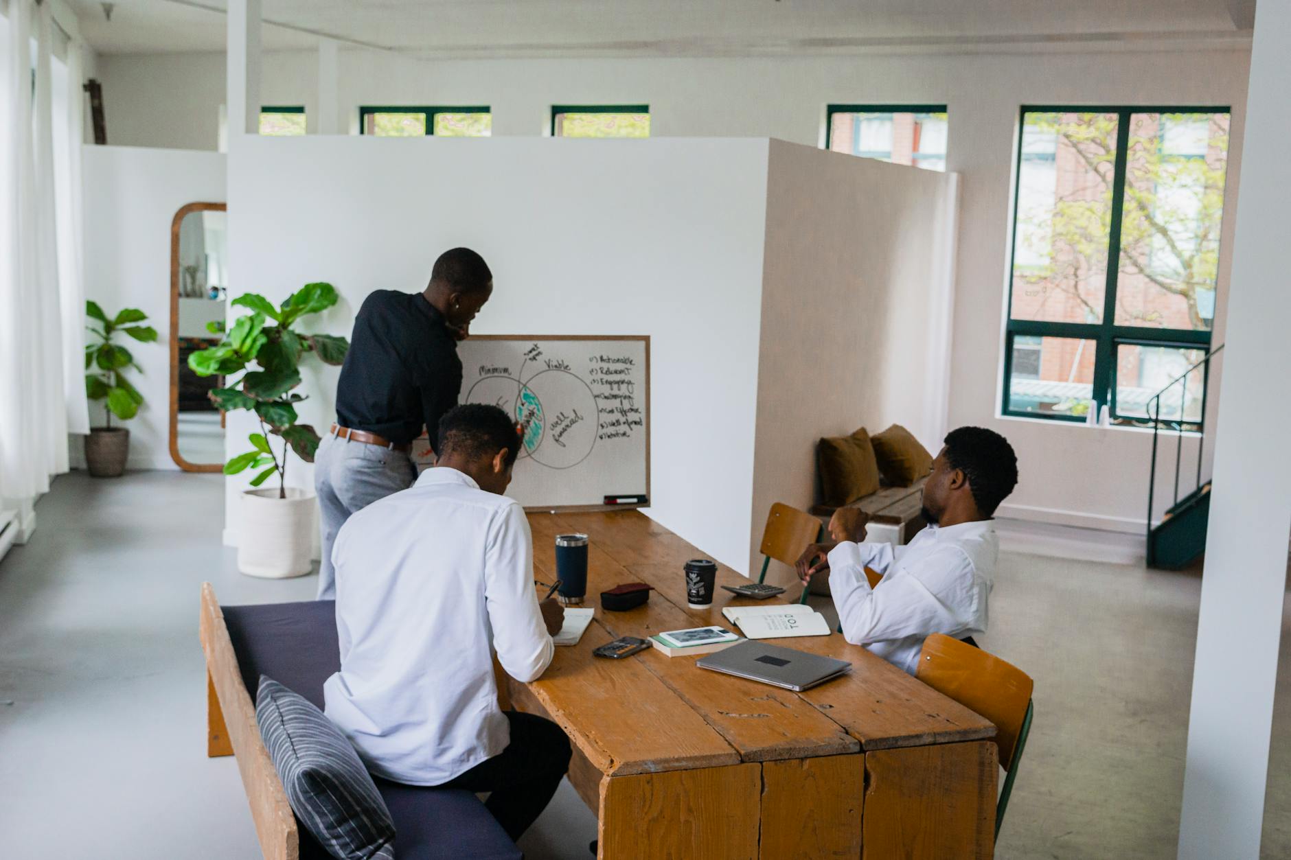 Two business professionals shaking hands over a partnership agreement