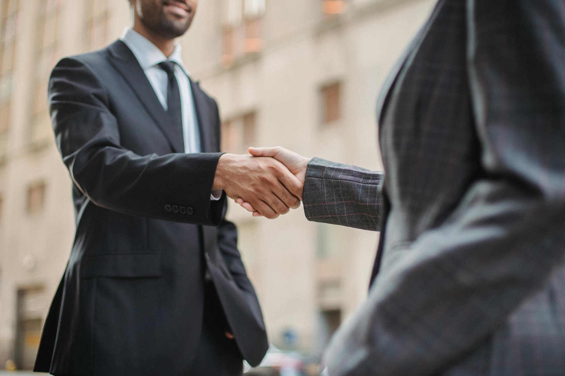 Professional handshake representing successful corporate partnership agreement