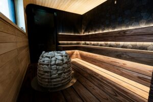 Warm wooden infrared sauna room interior with bench seating and ambient lighting
