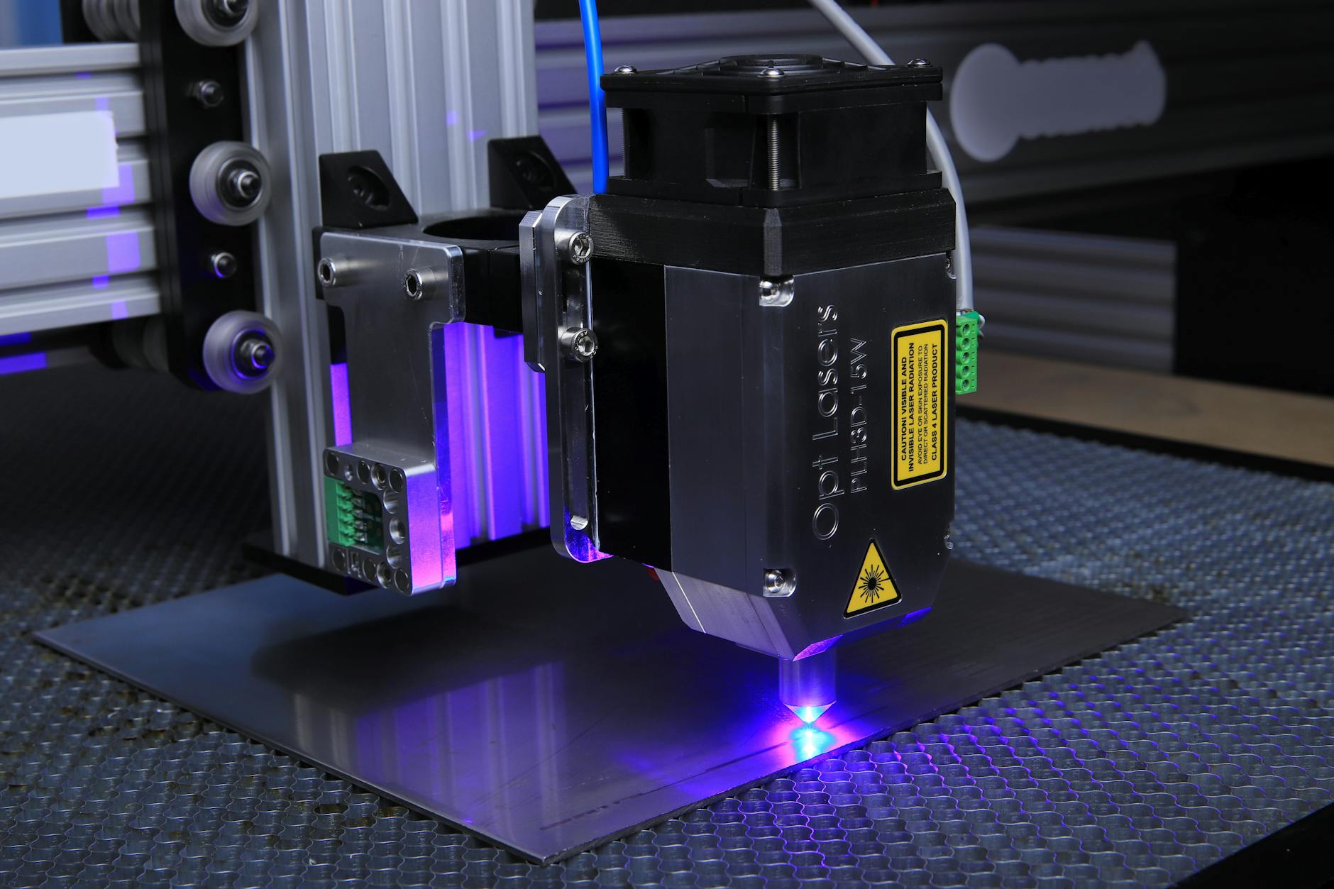 Close-up of a laser engraving machine etching a design onto a wooden surface