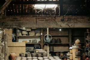 A pottery studio with multiple wheels set up for a group class session