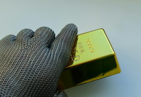 Stacked gold bars representing gold as a safe-haven asset for investors
