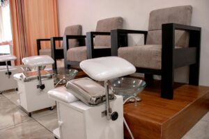 Professional nail salon interior with manicure stations and modern equipment
