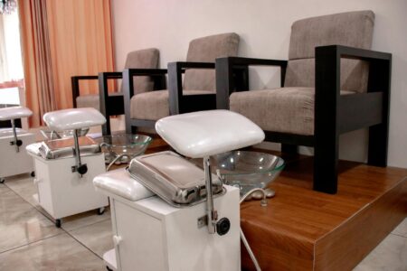 Local Nail Salons Generate Revenue Through Corporate Manicure Services Professional nail salon interior with manicure stations and modern equipment