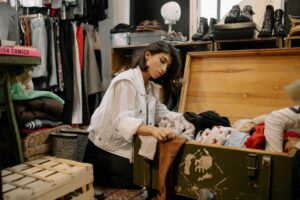 Interior view of a thrift store with clothing racks and vintage items displayed