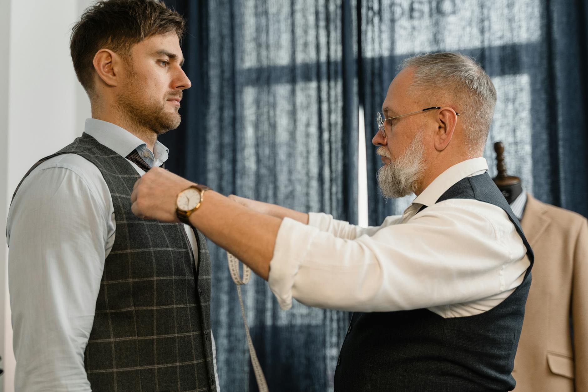 Person getting suit jacket fitted and measured for alterations