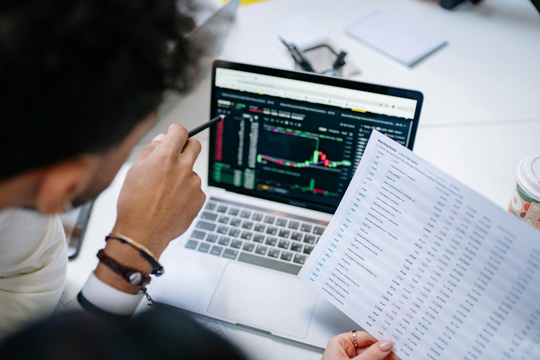 Laptop displaying financial planning software and charts