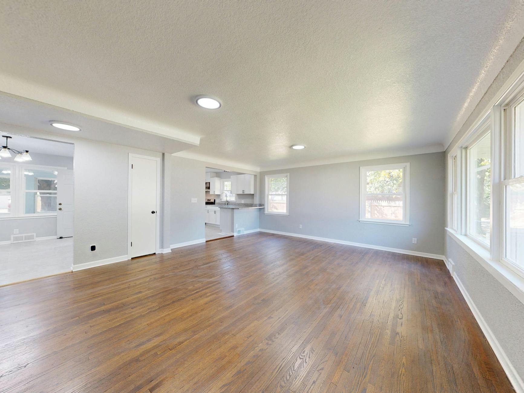 Modern home interior with open floor plan and large windows suitable for virtual tour photography