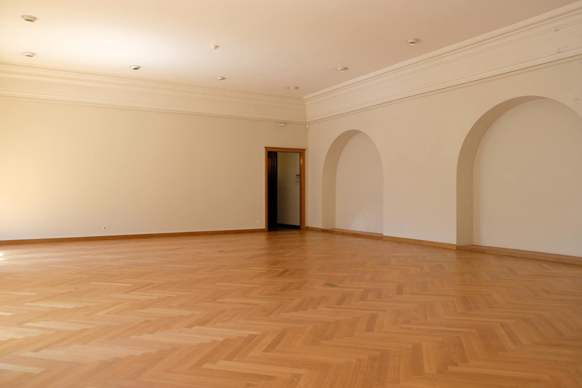 Empty dance studio with hardwood floor and mirrored walls