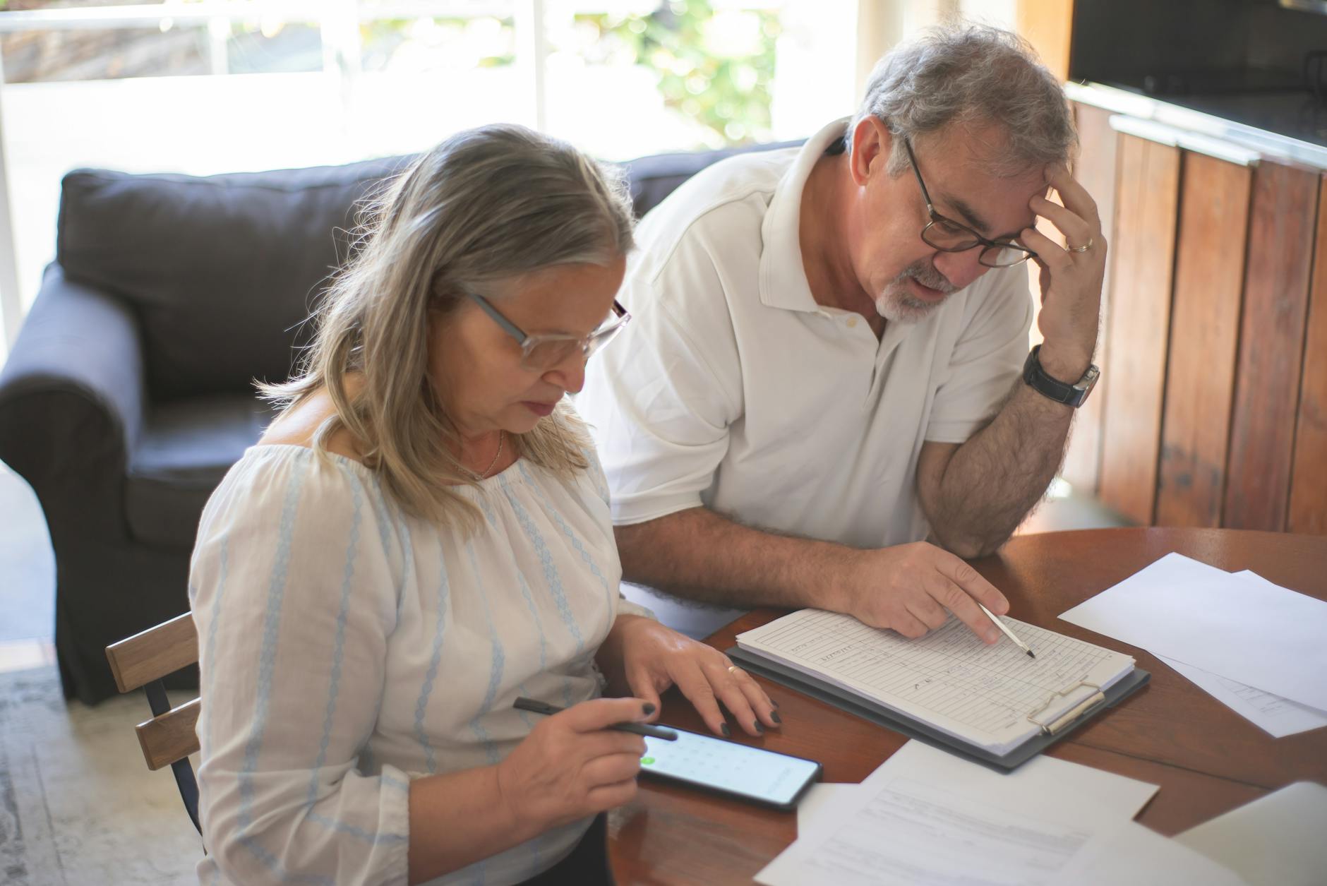 Senior couple reviewing financial planning documents together at home