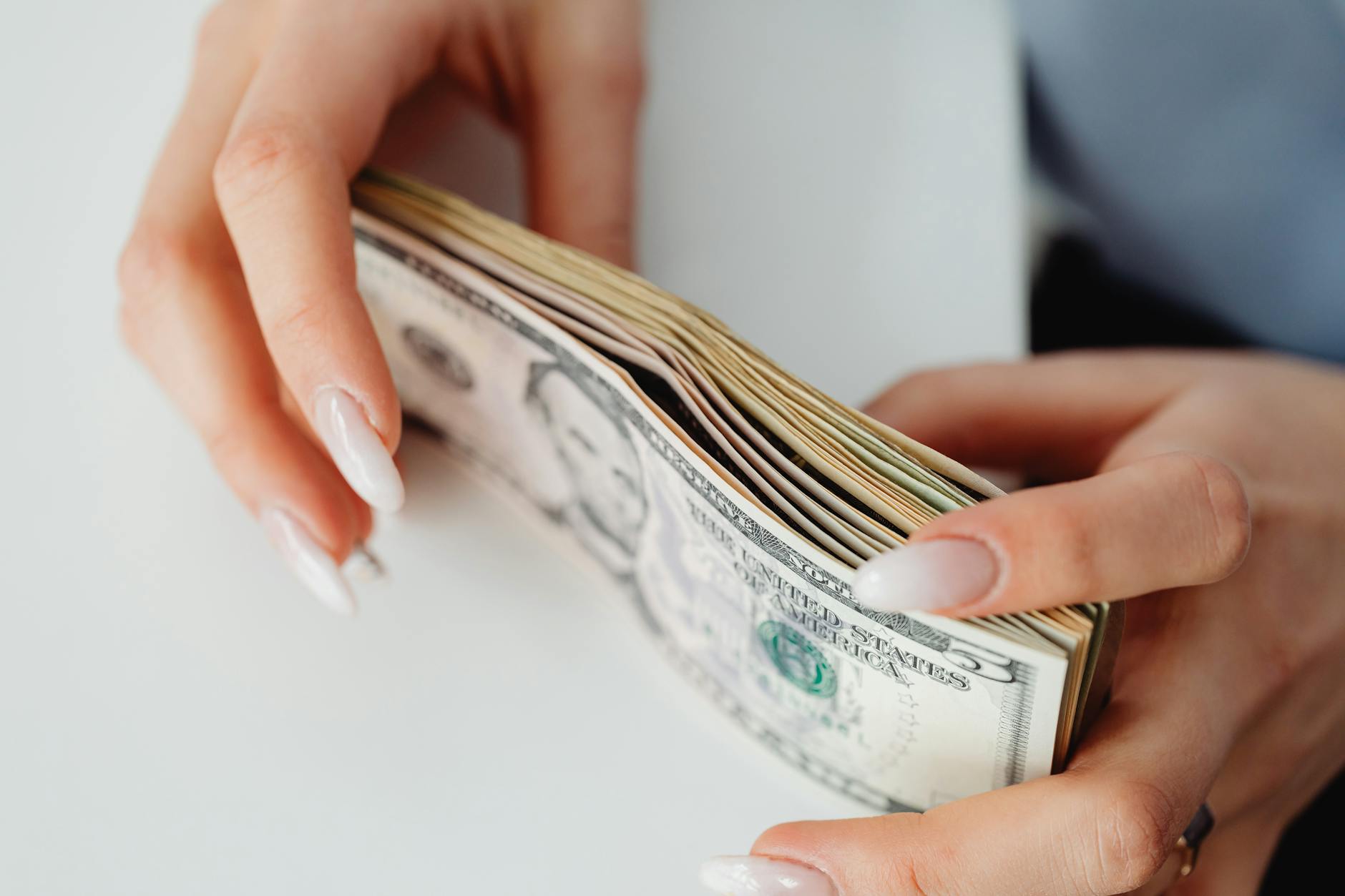 Stack of currency and financial papers representing dividend income and investment returns