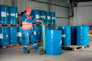 Large oil storage barrels at an industrial facility representing commodity supply infrastructure